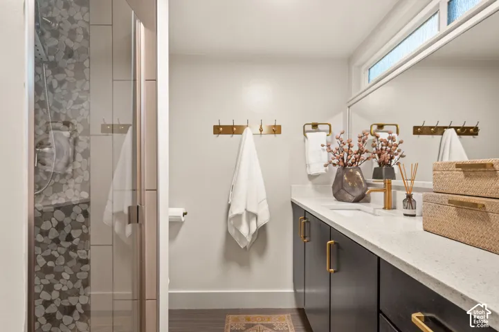 Glass-enclosed shower with pebble-tile accent