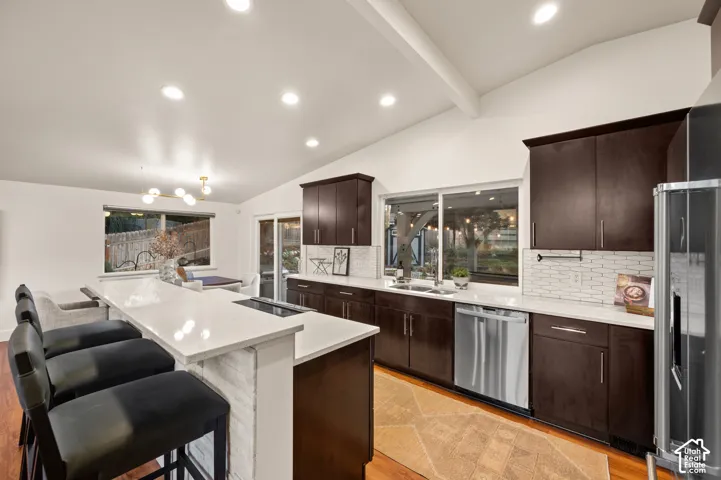Vaulted ceilings, recessed lighting, and rich wood-finish cabinetry