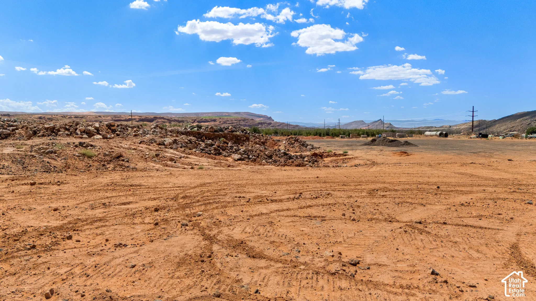 Expansive undeveloped land featuring natural terrain and distant mountains