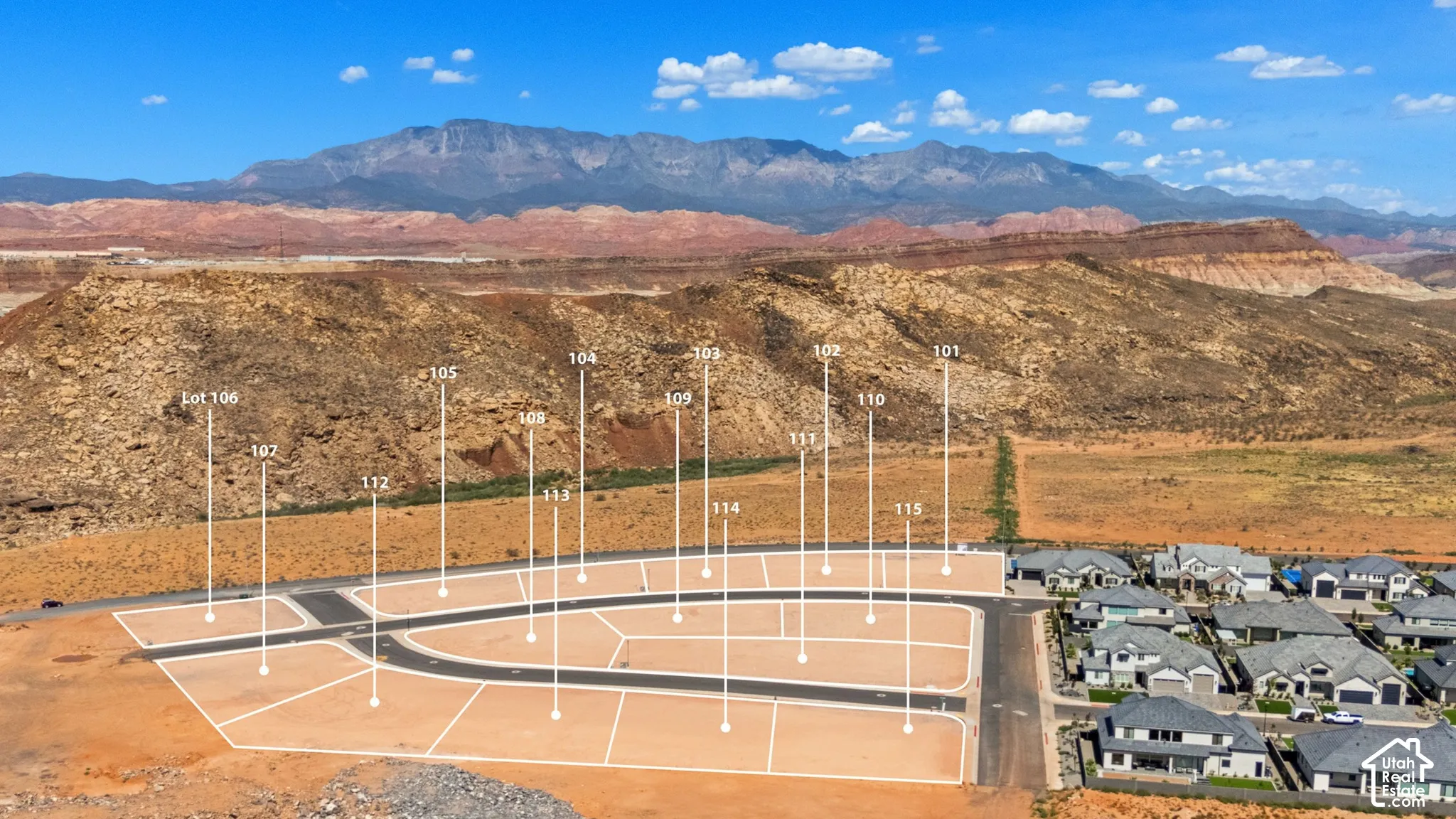 Developed lot subdivision with paved roads, surrounding residential structures, and mountain backdrop