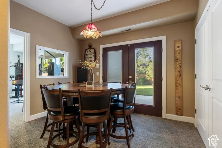 Plush carpet flooring, recessed ceiling lighting, French doors, and an interior pass-through window