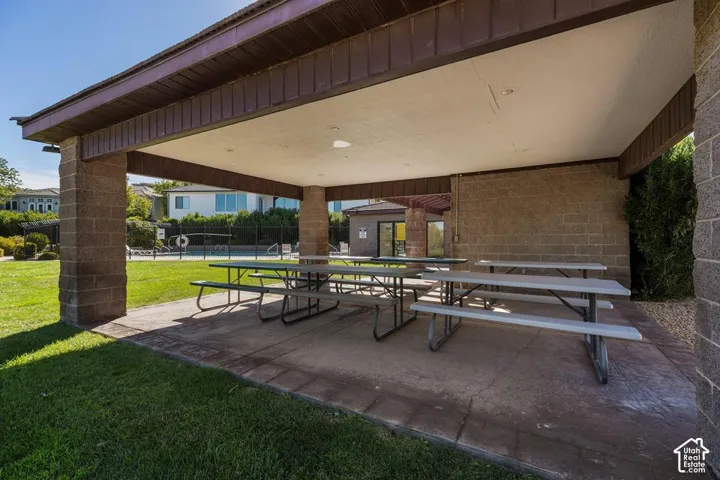 Covered patio with recessed lighting, concrete flooring, and stone-finish support columns