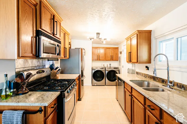 Warm wood cabinetry with dark hardware and light-toned countertops