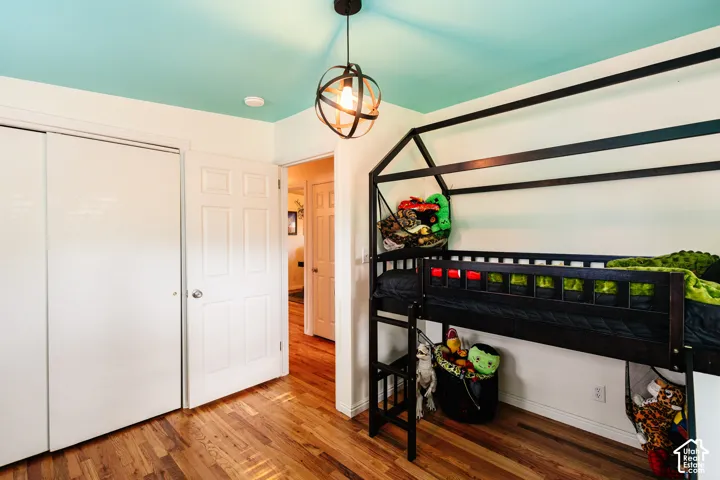 Wood-finish flooring with a multi-panel door and white trim