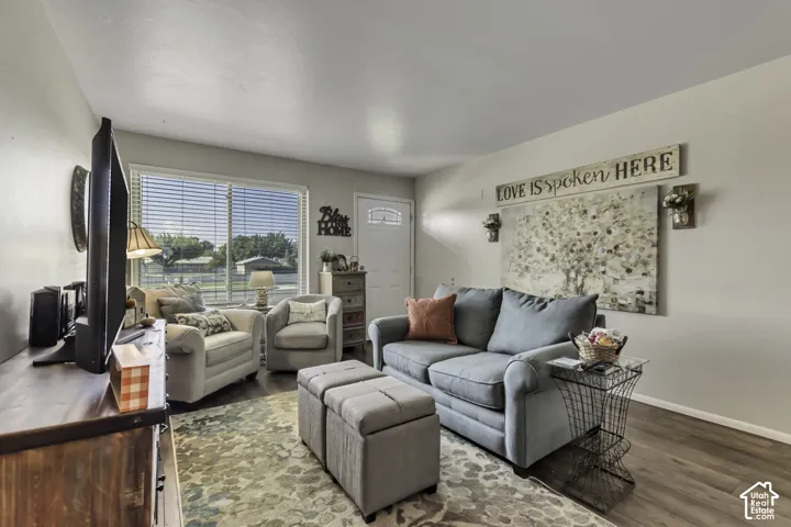 Neutral wall color, wood-finish flooring, and a front entry door with decorative glass