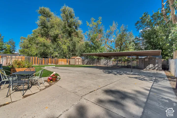 Expansive concrete patio with integrated carport structure