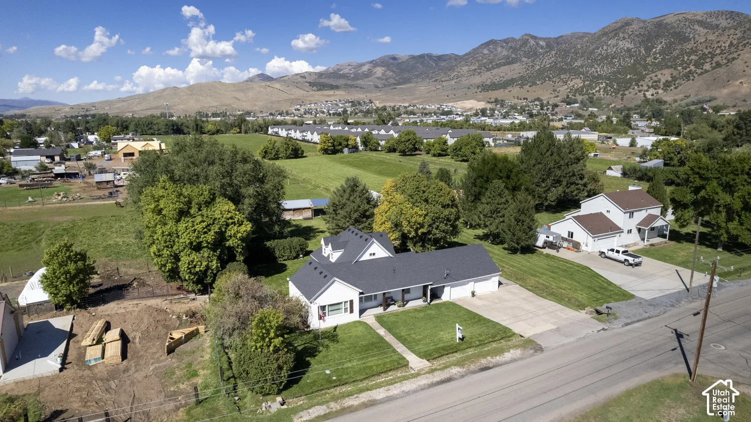 Single-story residence with a dark shingle roof, two-car garage, and a concrete driveway