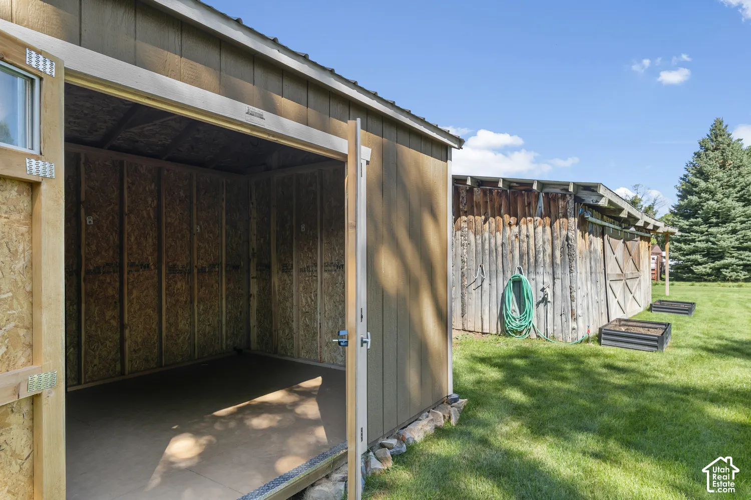 Storage shed with single window and double doors