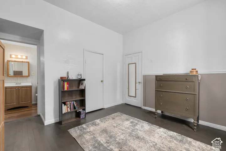 Dark wood-finish flooring with white walls and wainscoting