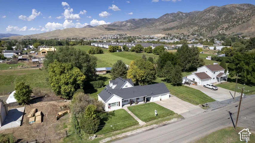 Single-story residence with a dark shingle roof, two-car garage, and a concrete driveway