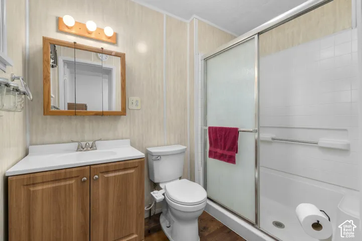 Wood-finish vanity with a white countertop and integrated sink