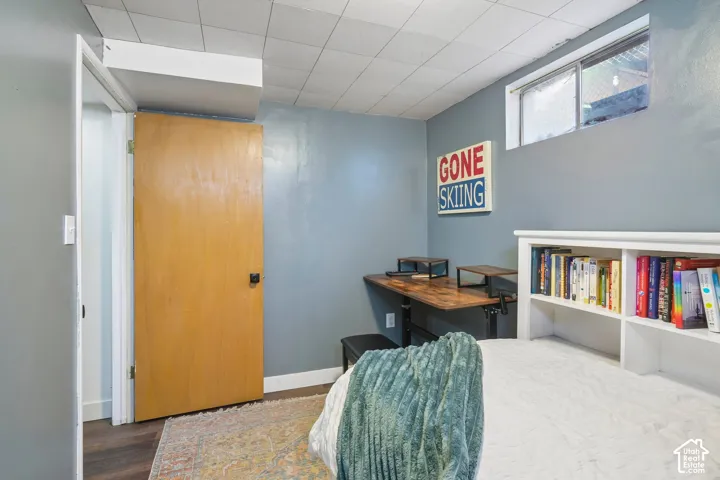 Built-in shelving unit, wood-finish flooring, and a window providing natural light