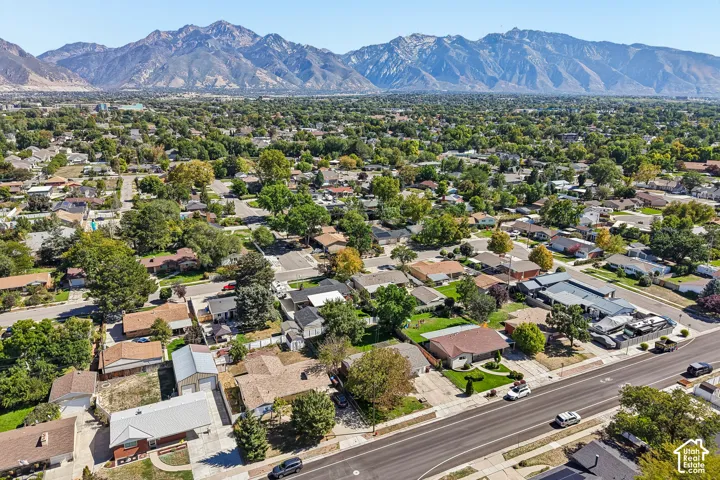 Expansive residential area with mature trees and mountain scenery