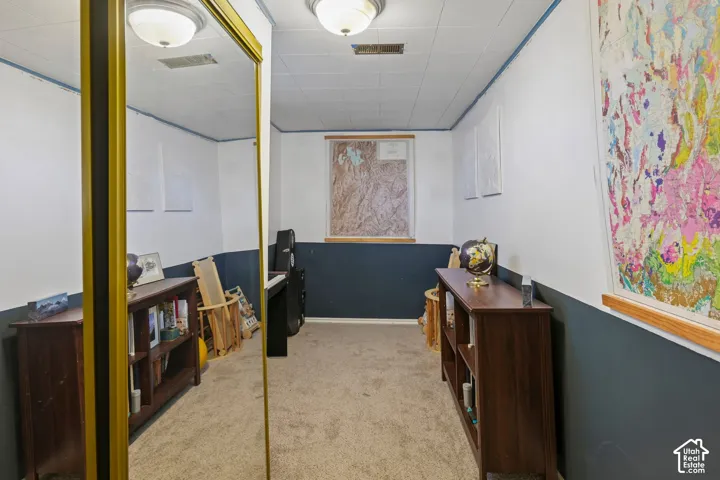Wall-to-wall carpet flooring, recessed window, drop ceiling, and flush mount lighting