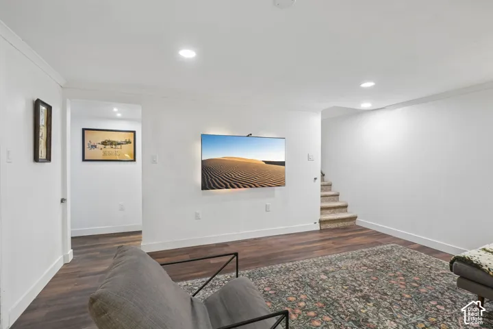 Recessed ceiling lighting, wood-finish flooring, and white painted walls