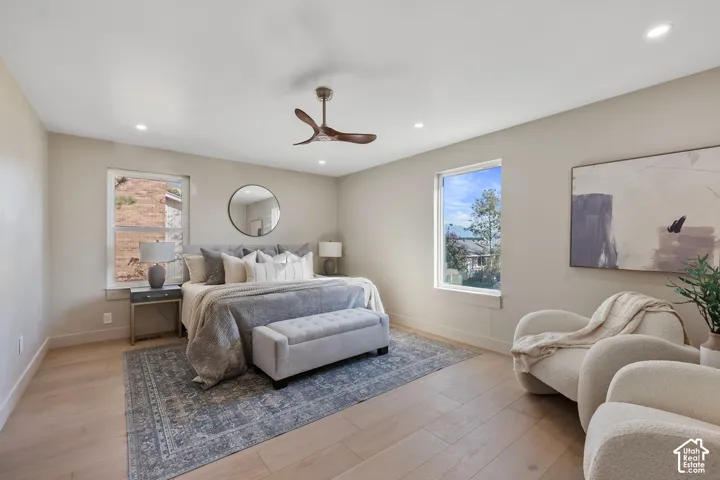 Recessed lighting, wood-finish flooring, and a ceiling fan with integrated lighting