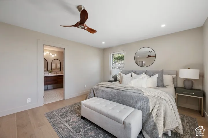 Wood-finish flooring with recessed lighting and a ceiling fan