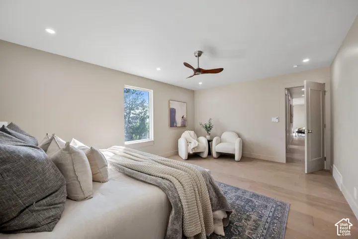 Recessed lighting, wood-finish flooring, single window, flush-panel interior door, and a ceiling fan with wood-tone blades