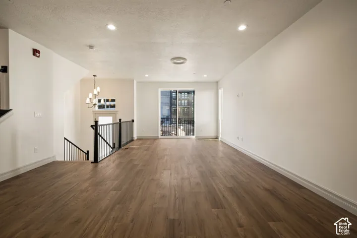 Expansive main living area featuring wood-finish flooring, recessed lighting, and a sliding glass door