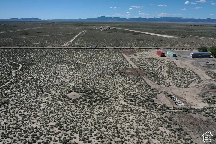 Expansive desert landscape with distant mountains under a clear sky