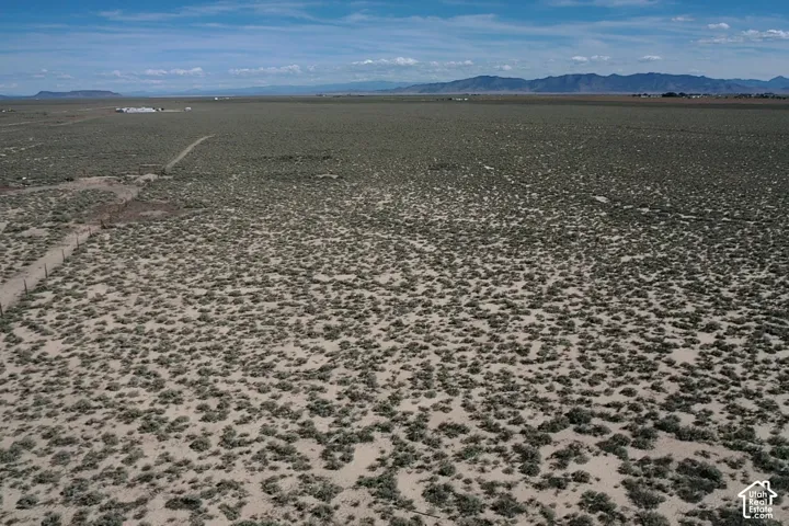 Expansive undeveloped land with sparse low-lying vegetation