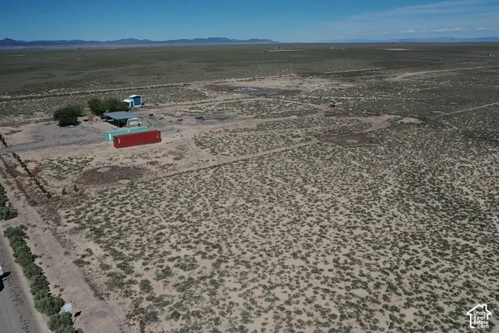 Expansive desert landscape featuring natural vegetation and distant mountains