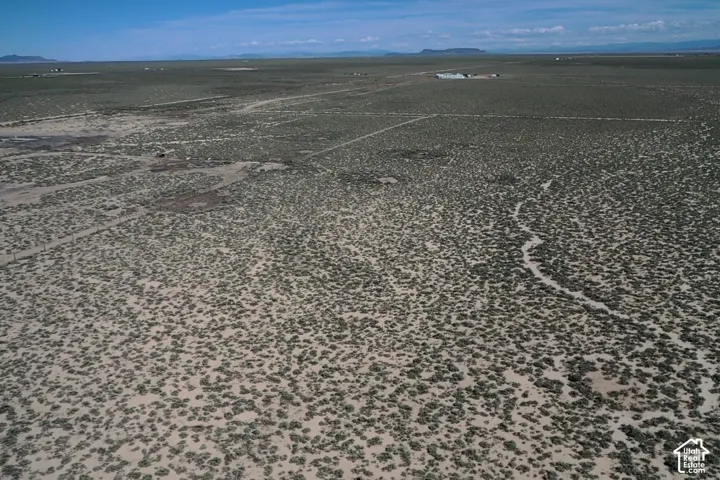 Expansive land parcel featuring natural terrain and distant mountains