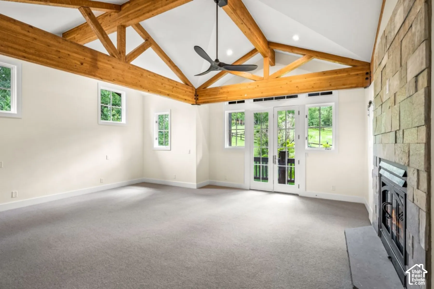 Vaulted ceiling with exposed wood beams, ceiling fan, and recessed lighting