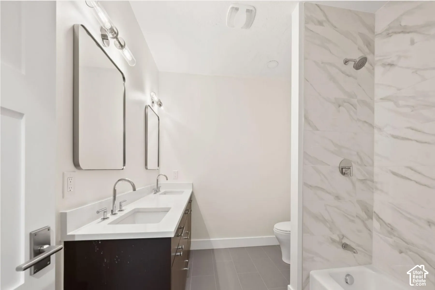 Dual vanity with integrated sinks, quartz countertop, and chrome faucets