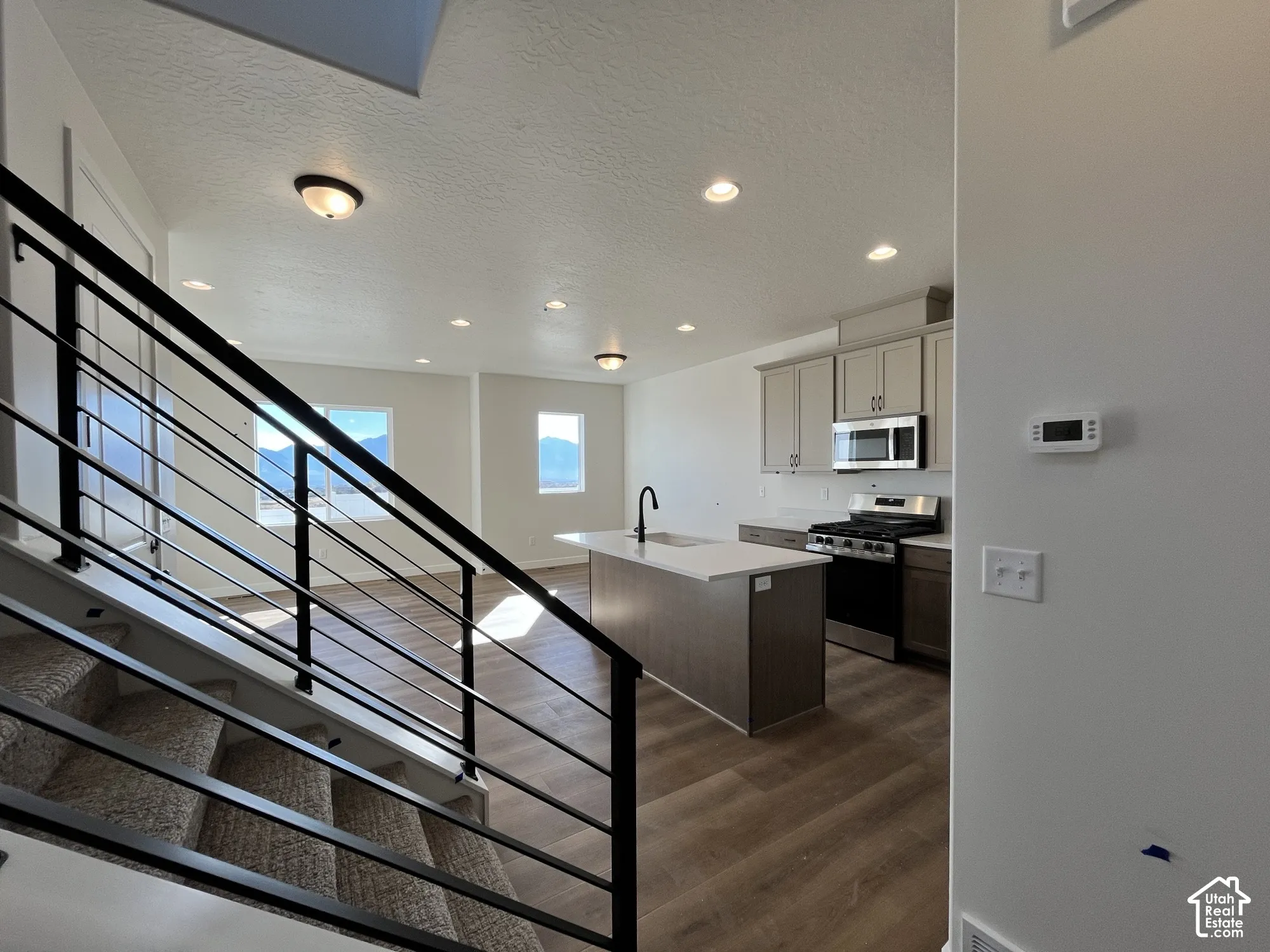 Open-concept living space with wood-finish flooring