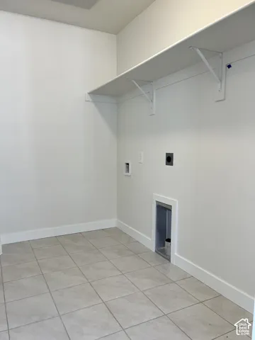 Tile flooring, wall-mounted shelving, built-in dryer vent, utility hookups