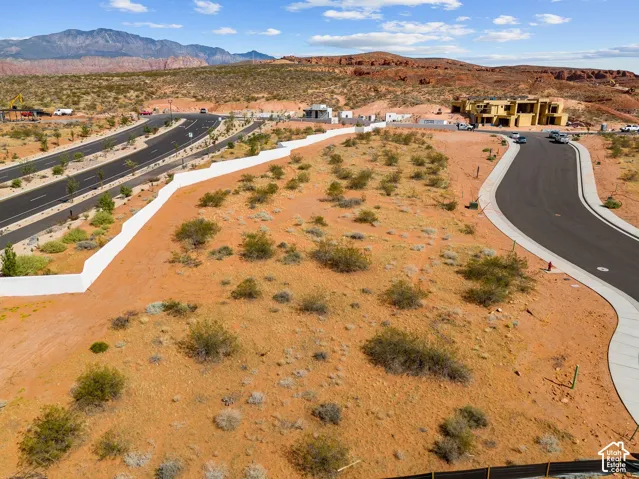 Expansive undeveloped land featuring natural desert landscaping and surrounding mountainous terrain