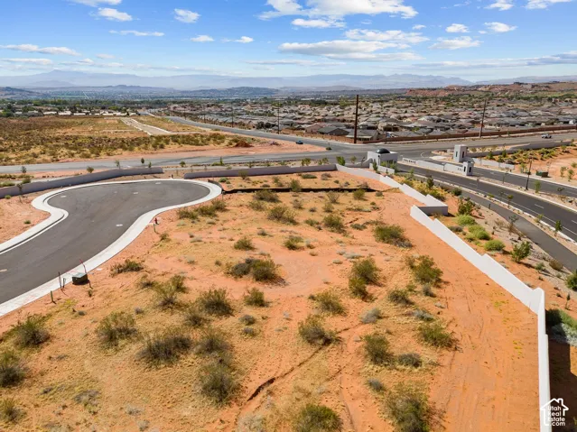 Expansive undeveloped land featuring a paved cul-de-sac and desert landscaping