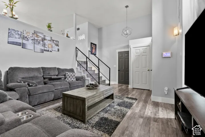 Wood-finish flooring throughout, complemented by a modern geometric pendant light fixture