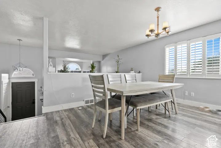 Wood-finish flooring throughout, with a classic chandelier and white plantation shutters