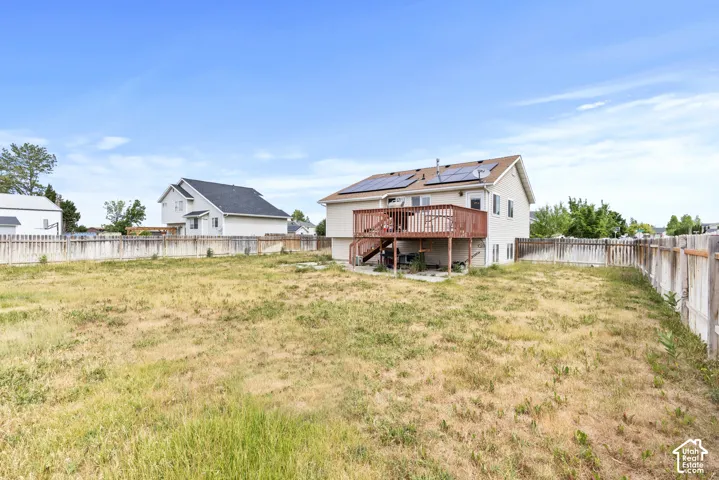 Expansive rear yard with a wooden privacy fence