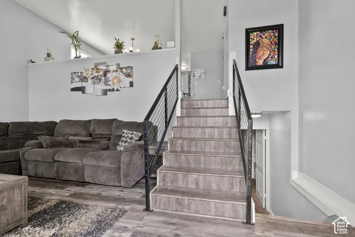 Wood-finish flooring throughout, complemented by a contemporary metal railing staircase