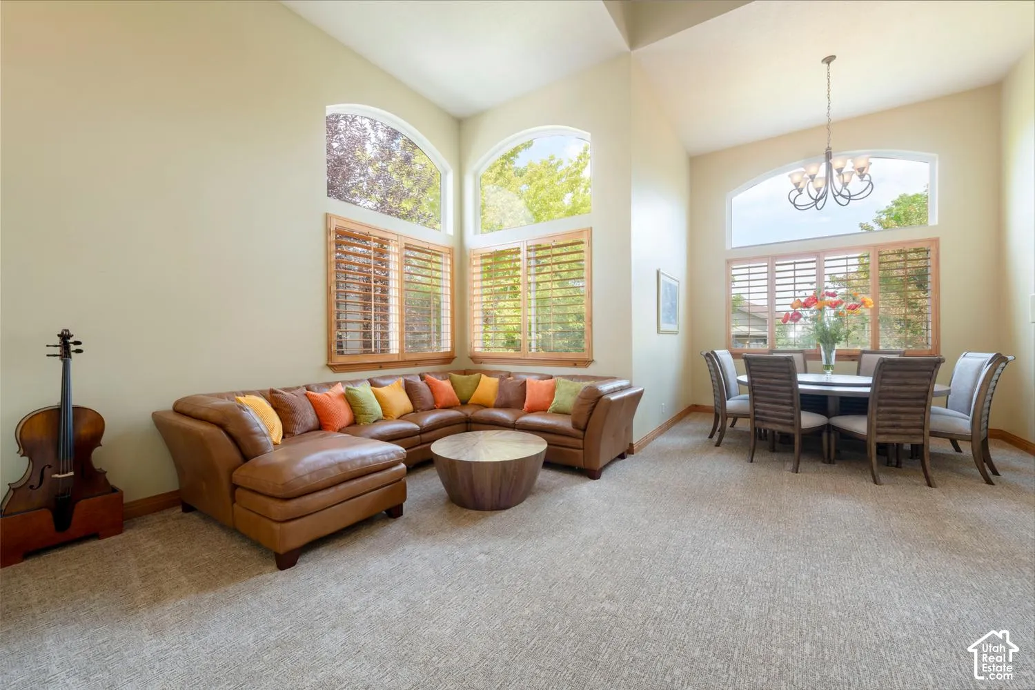Vaulted ceilings, arched windows, and light-toned walls with wood trim
