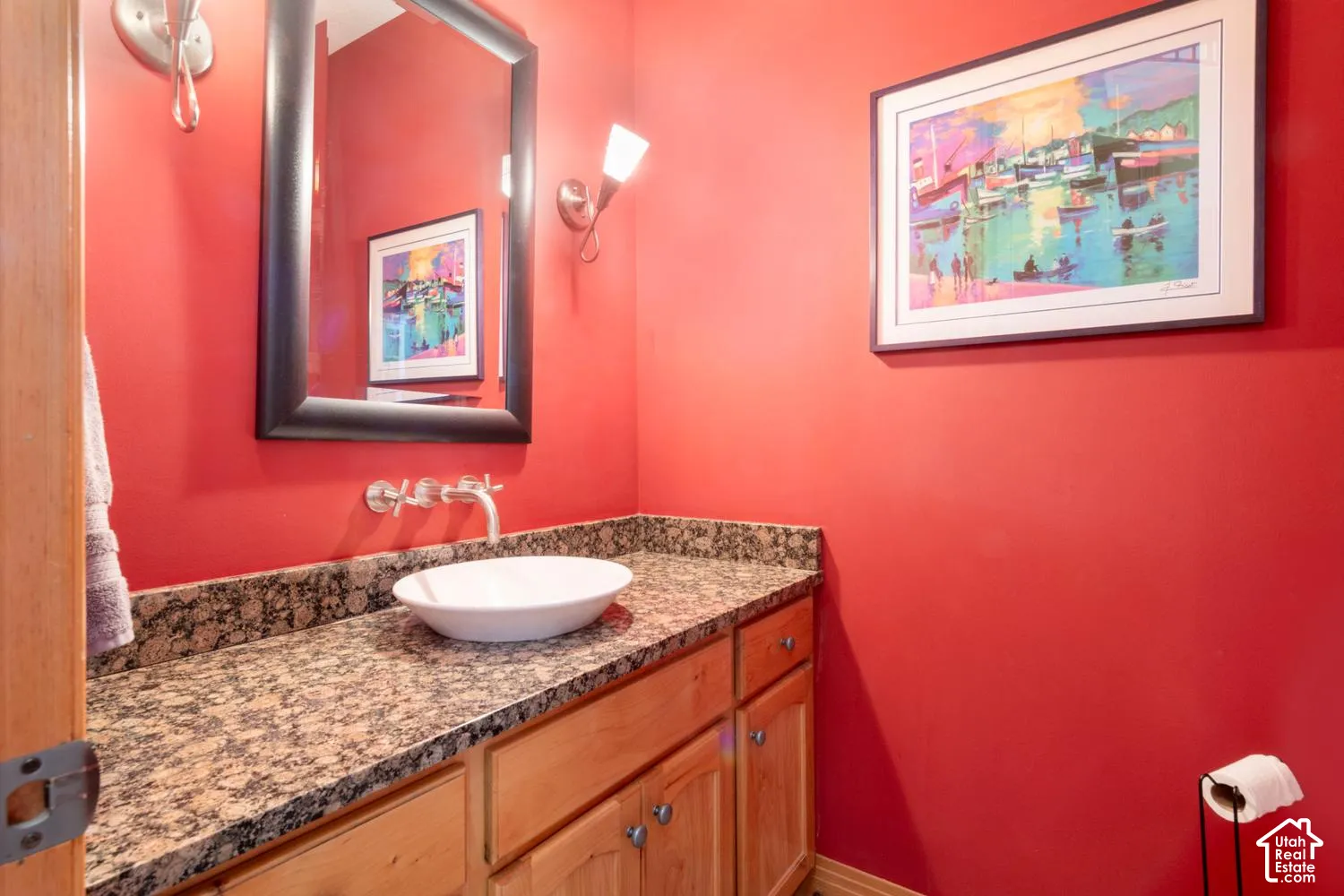 Vanity with granite-style countertop, wall-mounted faucet, and vessel sink