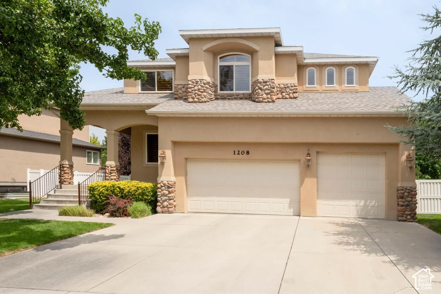 Stucco exterior with stone accents and an arched entry