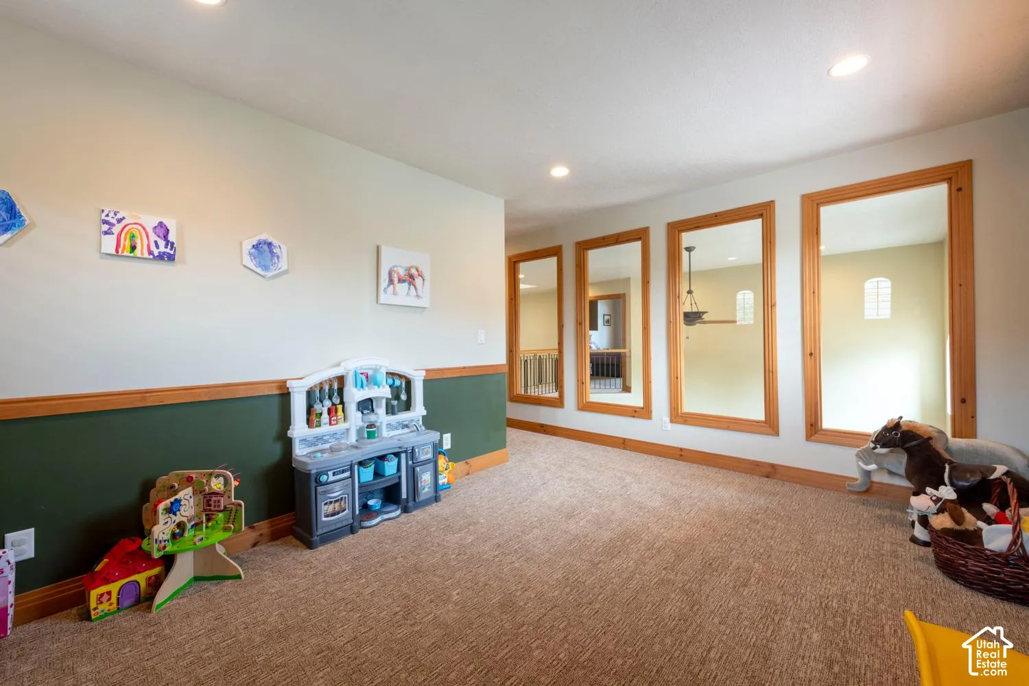 Carpeted flooring, recessed ceiling lighting, wood-trimmed openings, and two-tone wall finishes