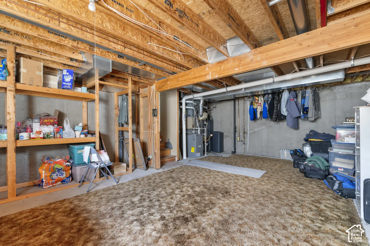 Unfinished basement space and built-in wood shelving