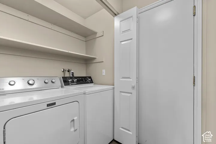Laundry area with built-in shelving and a paneled door