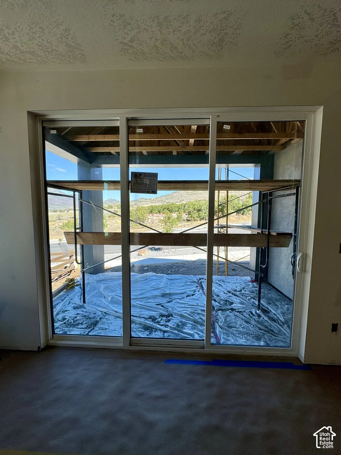 Sliding glass doors with white framing and exterior scenery