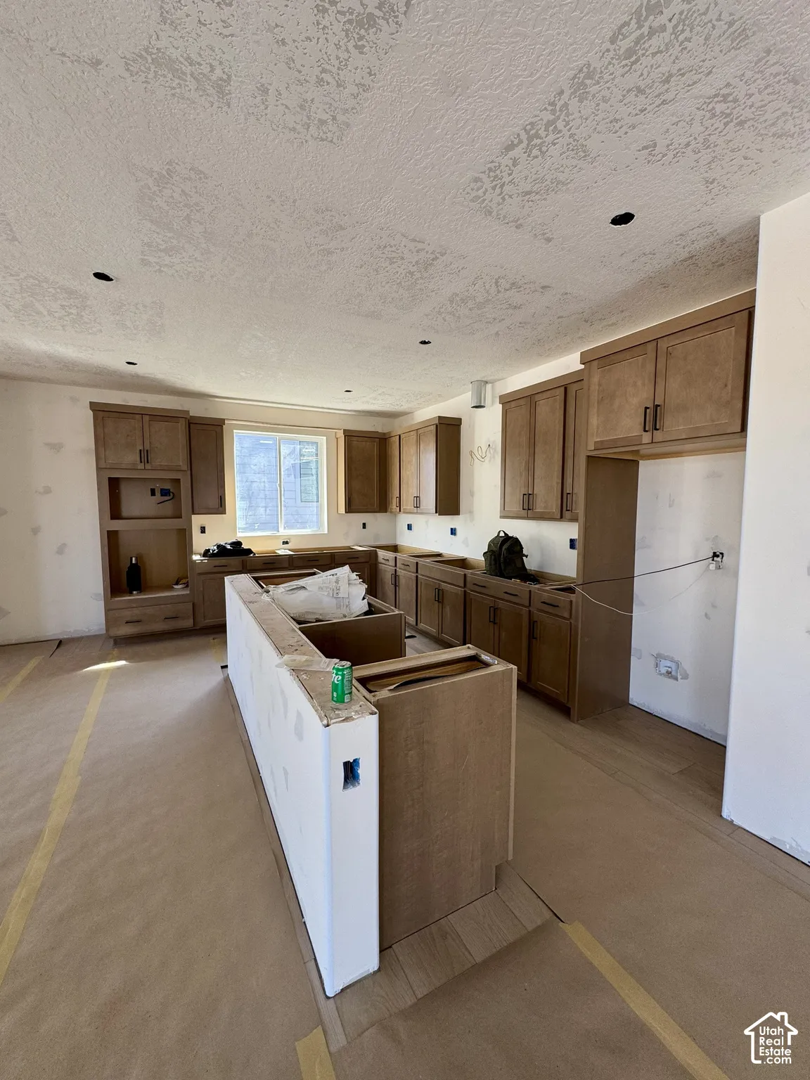 Kitchen featuring wood-finish cabinetry, recessed lighting, and a center island with integrated cabinetry
