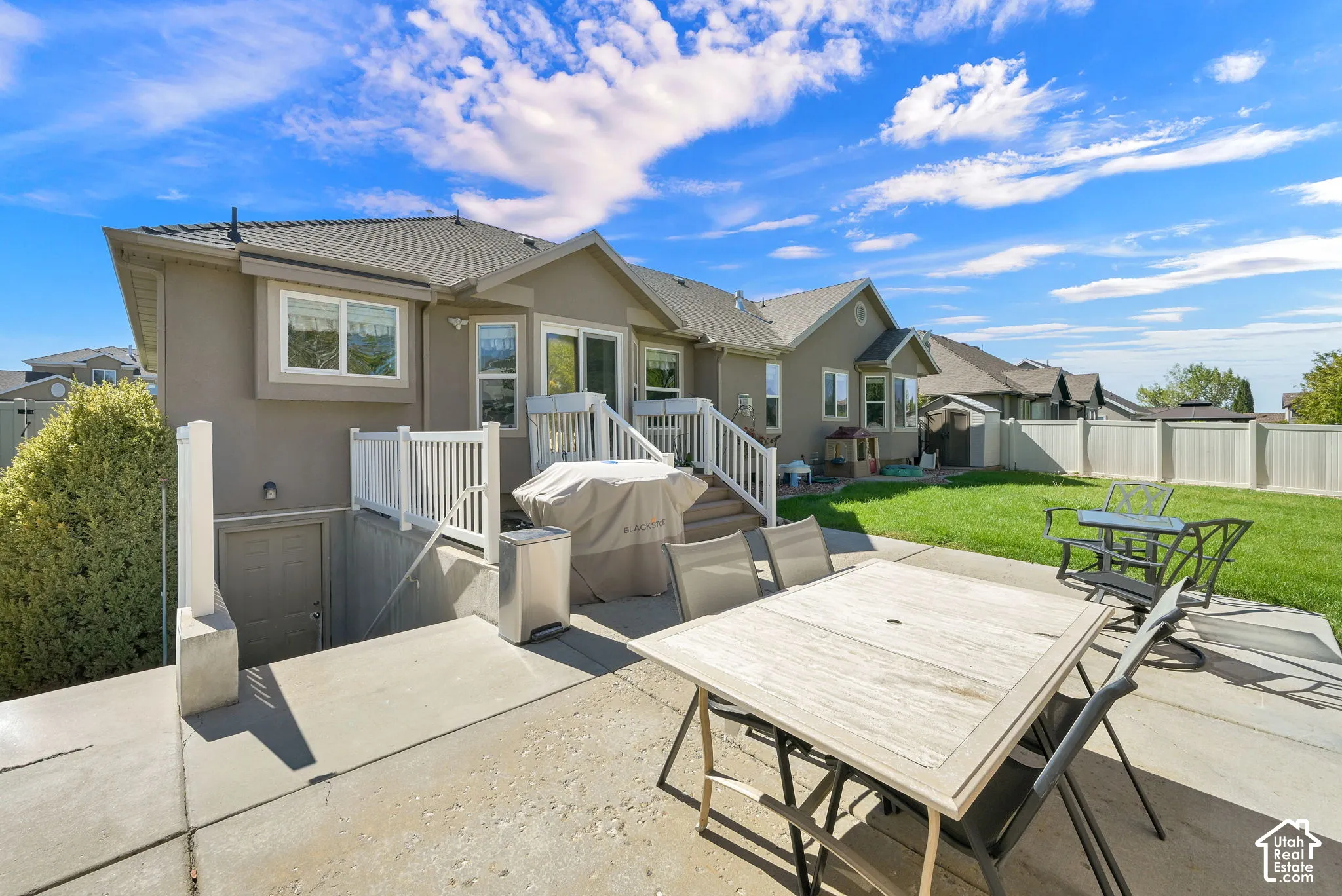 Expansive concrete patio with direct access to a manicured lawn