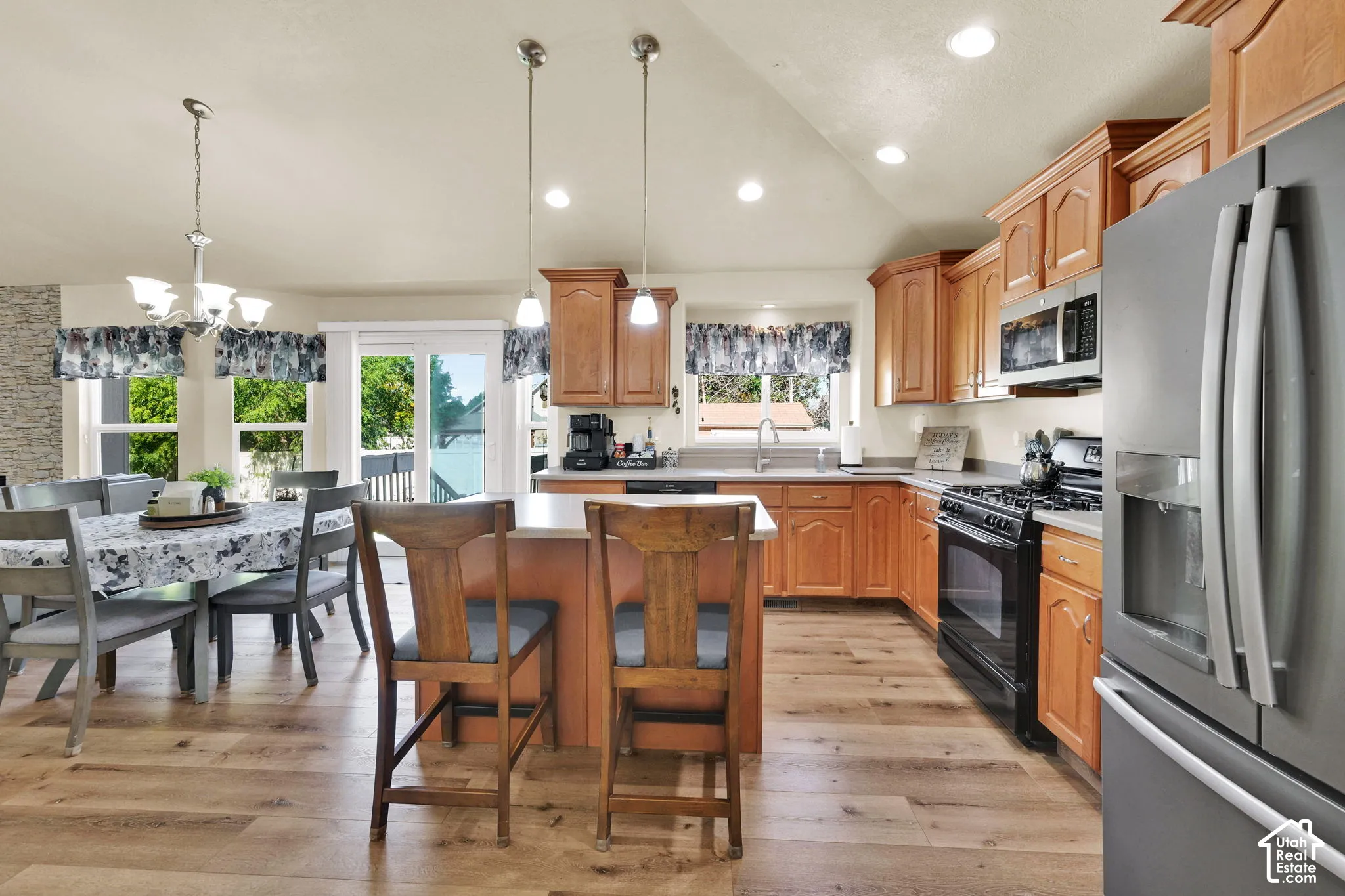 Kitchen featuring wood-finish flooring, recessed lighting, wood cabinetry, and stainless steel appliances