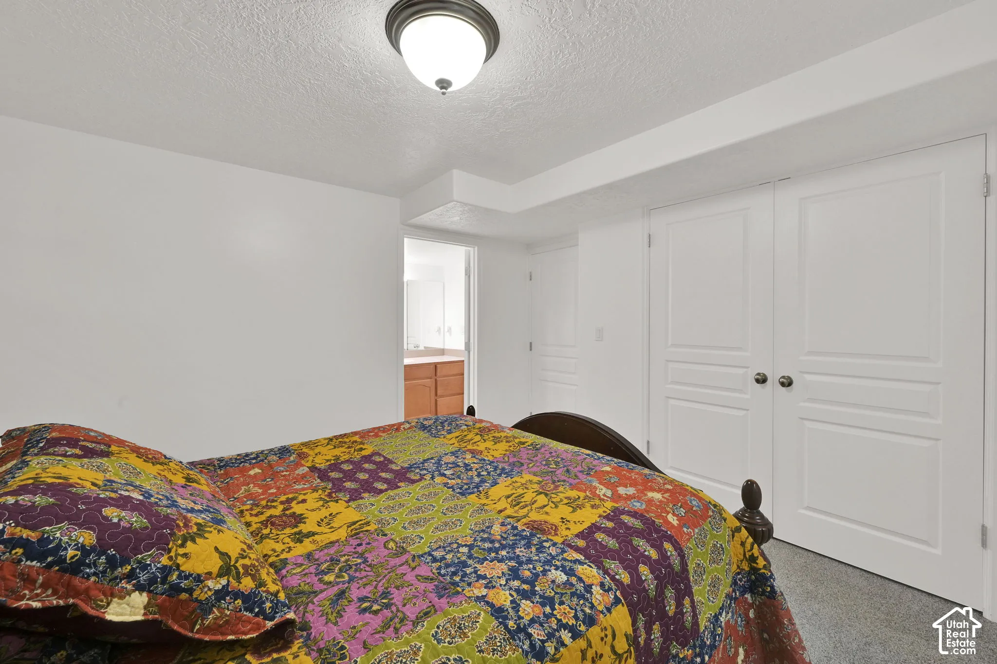 Recessed ceiling light fixture, bi-fold closet doors, and neutral wall tones