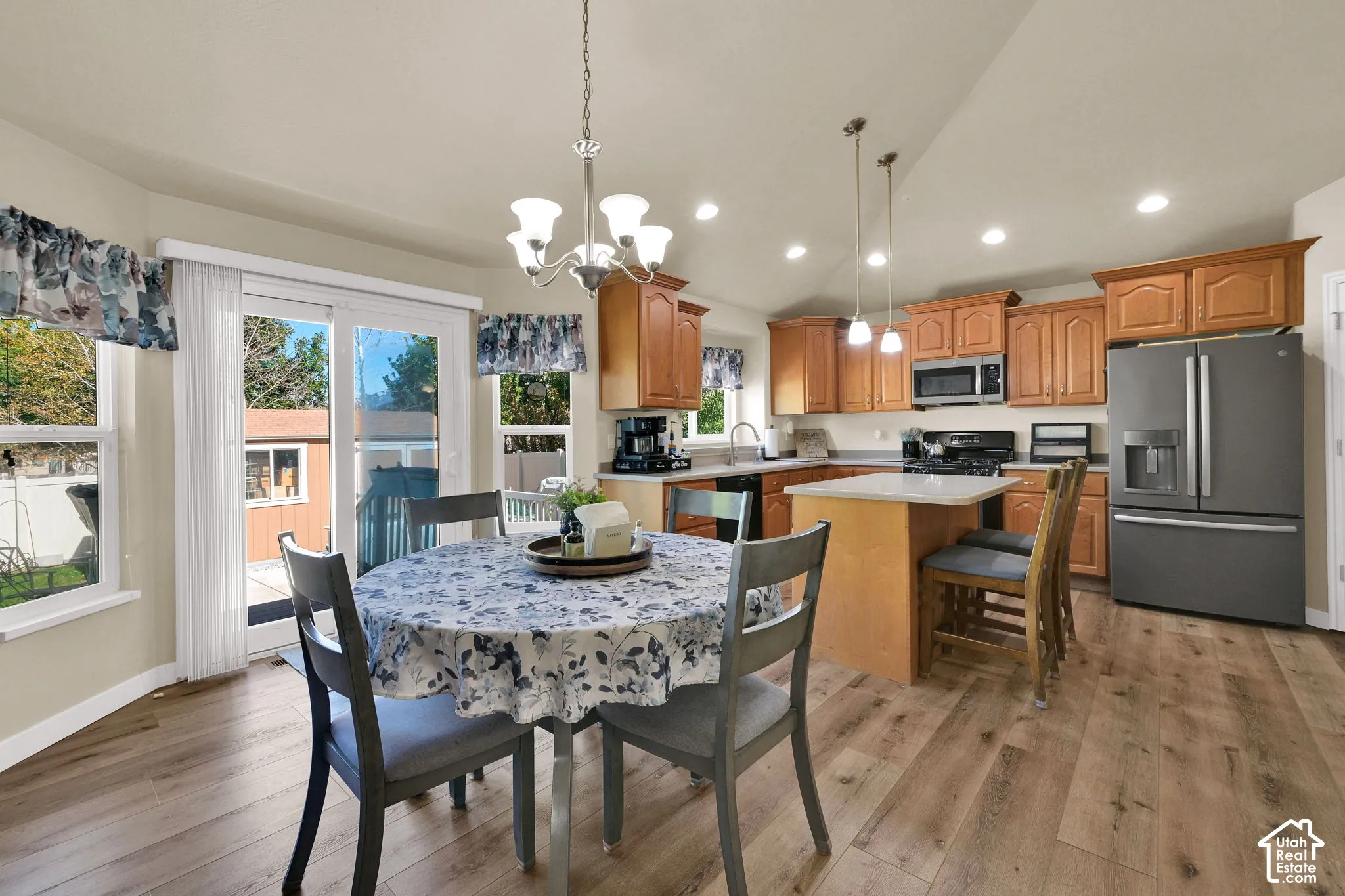 Kitchen featuring wood-finish flooring, recessed lighting, and a center island with pendant lighting