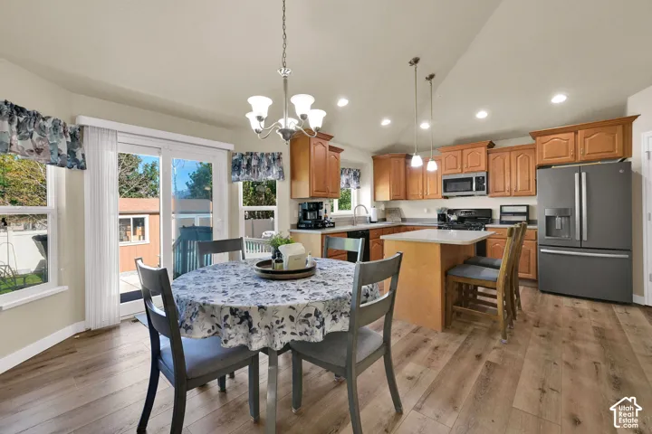 Kitchen featuring wood-finish flooring, recessed lighting, and a center island with pendant lighting